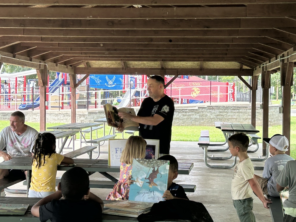 John Moore reading to students.