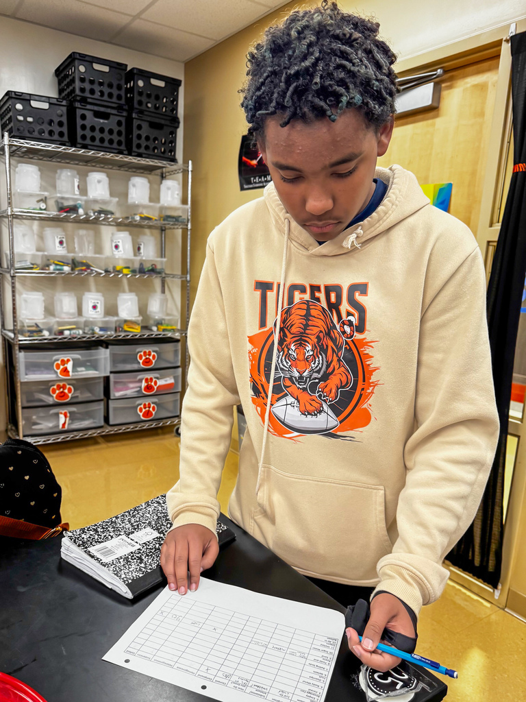 To review their learning standards, 8th graders rotated through stations, tackling questions that pushed them to sort and classify items like true scientists in Kelly Jackson’s science class at Waynesville Middle School. Stations were filled with everyday items—an aluminum cube, an empty can, rusty metal, baking soda, fruit, gelatin, cereal, pasta and beans, sand, sugar water, melted crayons, and even air trapped in a balloon. At each stop, they answered questions such as: · Is it a metal, substance or mixture? How do you know? · Is it heterogeneous or homogeneous? · Is it an element or compound? · What variations make this easily categorized? · How is a colloid different from a suspension? This hands-on learning turned simple objects into a real-world learning experience.
