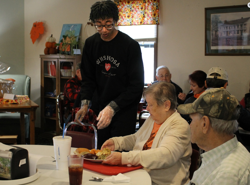 Waynesville High School students assisted with the Thanksgiving meal at the Waynesville-St. Robert Senior Citizens Center. Students from both HOSA (future health professionals) and the varsity girls basketball team and their sponsors/coaches helped make the day special. In addition, the basketball players and coaches selected angels from the tree to sponsor for the holidays and later purchased them gifts.