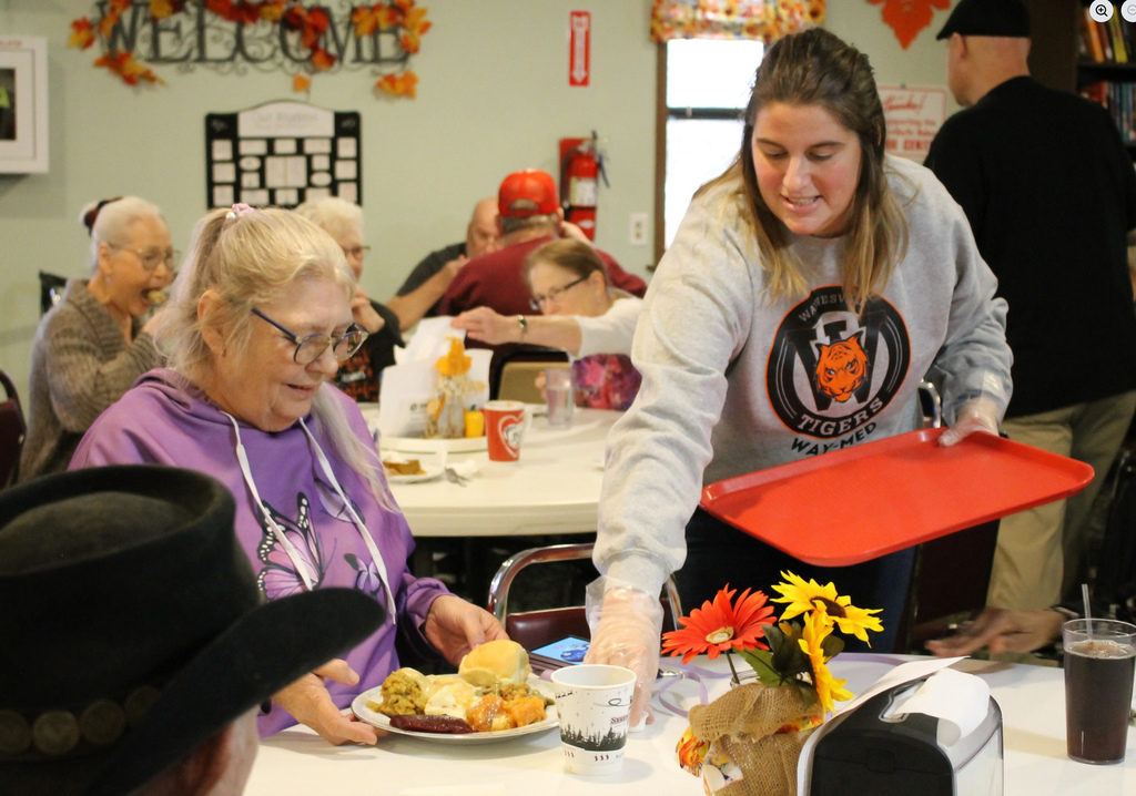 Waynesville High School students assisted with the Thanksgiving meal at the Waynesville-St. Robert Senior Citizens Center. Students from both HOSA (future health professionals) and the varsity girls basketball team and their sponsors/coaches helped make the day special. In addition, the basketball players and coaches selected angels from the tree to sponsor for the holidays and later purchased them gifts.