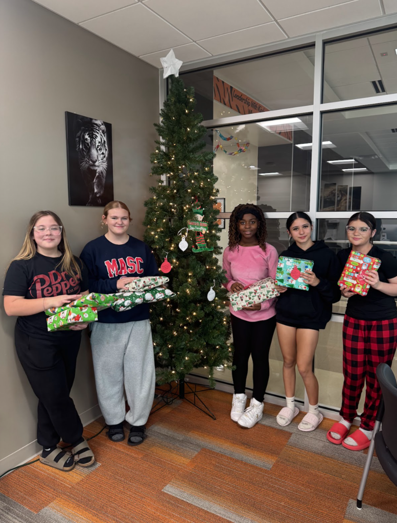 Before the holiday break, Waynesville Middle School Student Council members assisted with organizing and decorating a giving tree, fundraising for gifts, shopping for their peers and wrapping the presents. They helped make the holidays a little brighter for 17 of their peers.