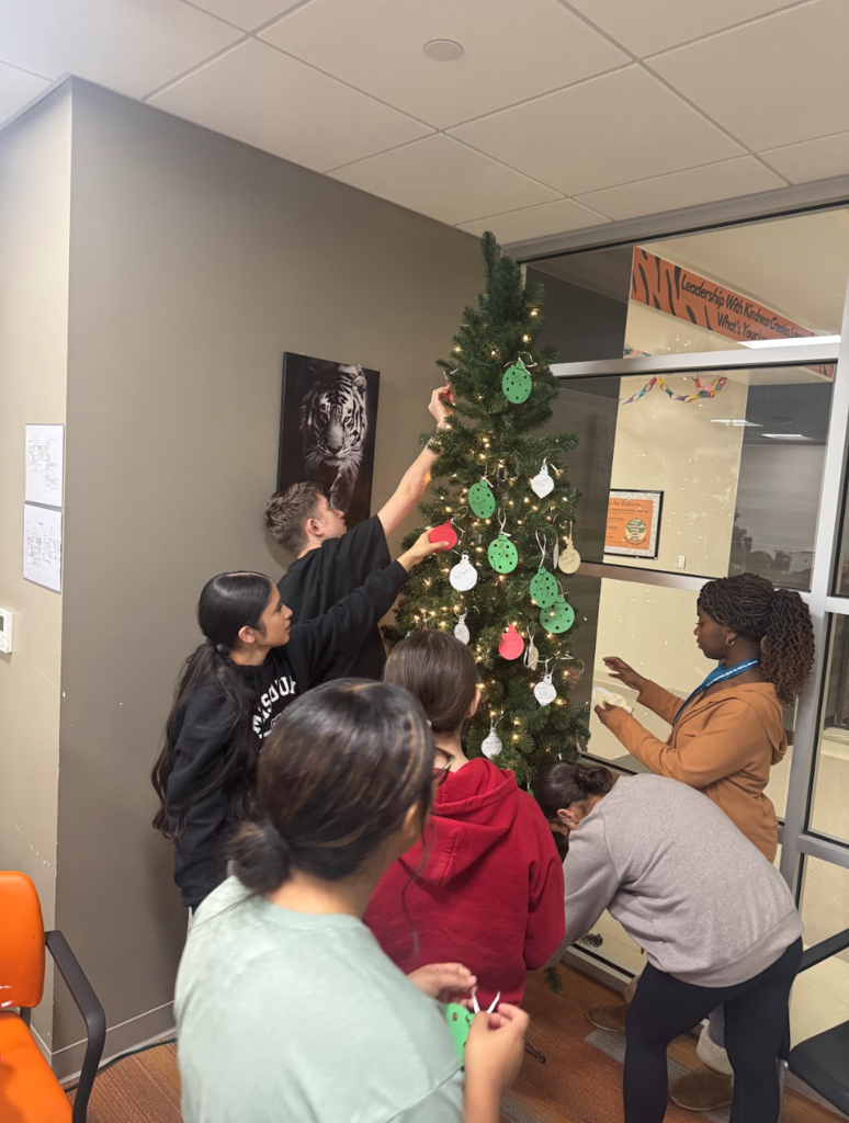 Before the holiday break, Waynesville Middle School Student Council members assisted with organizing and decorating a giving tree, fundraising for gifts, shopping for their peers and wrapping the presents. They helped make the holidays a little brighter for 17 of their peers.