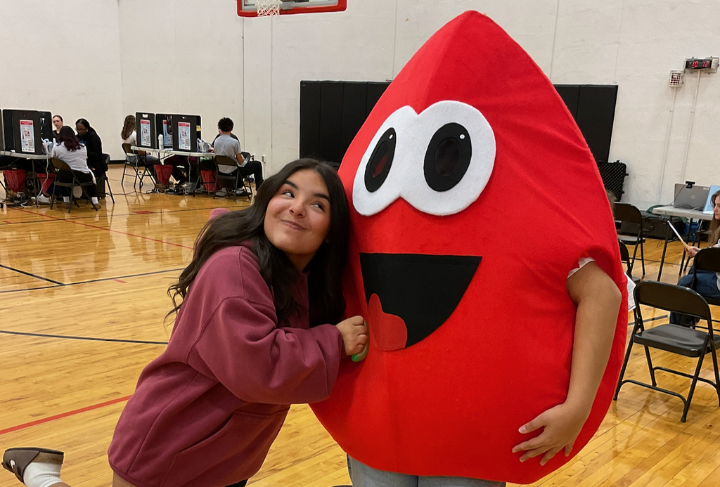 Student giving the mascot a hug