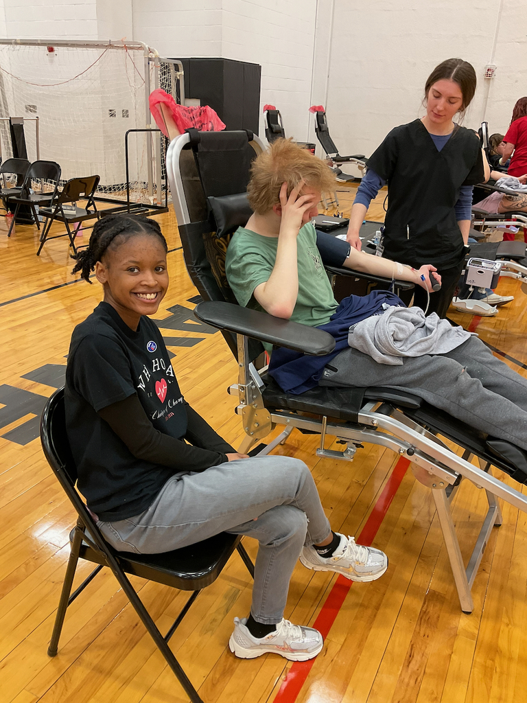 Student sitting next to student giving blood