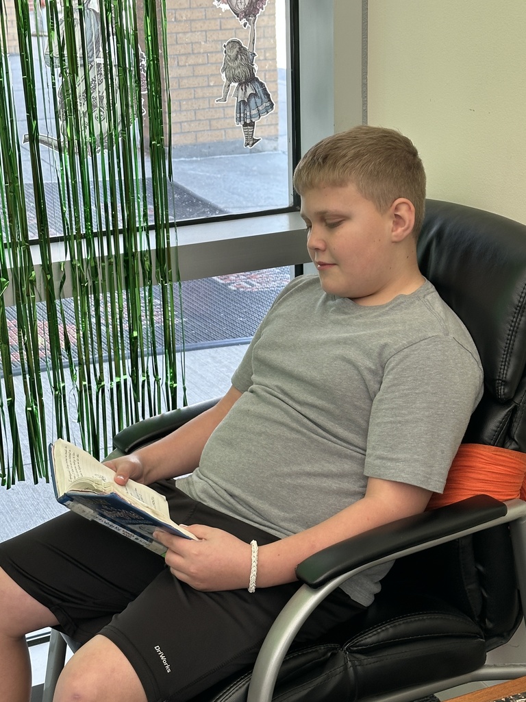 Student sitting in chair reading 