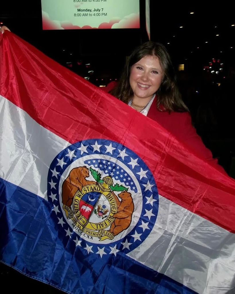 Faith Bohrer with the flag from the State of Missouri