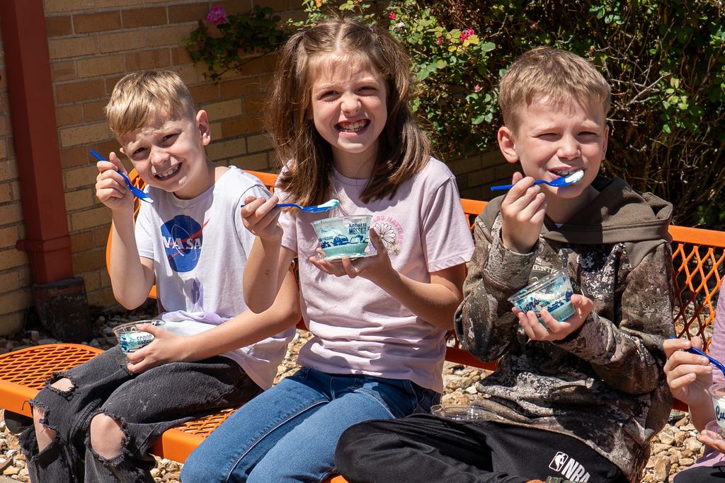 Students eating custard. 