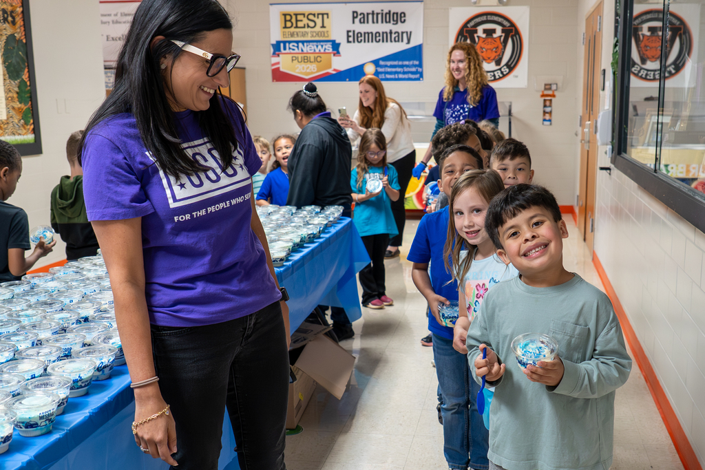 Volunteers and students with custard