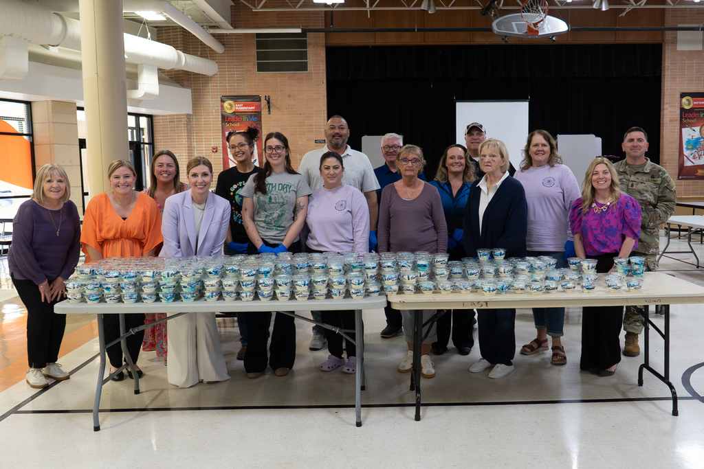 In celebration of April being the Month of the Military Child, Culver’s of St. Robert provided custard sundaes to students and staff at Waynesville Schools during the week of April 20-24, including at East Elementary on April 22, 2026.  A special thanks goes to Shaun Morris of Culver’s who donated approximately 7,000 custard sundaes, Ed Morse Ford for providing the vehicles for transporting the custard, Rick Harne for organizing the week, Paula Tackett for organizing the volunteers, Infuze Credit Union, USO, The Pulaski County Sewer District #1, and other volunteers who delivered and served the custard.  At East Elementary, Shaun Morris, owner of Culver’s in St. Robert, Stephanie Linville, FBC for Culver’s in the St. Louis area, and Michael Wieland, director of operations at Culver Franchising System, joined the volunteers to help hand out the custard. They are pictured next to a thank you sign created by East students.