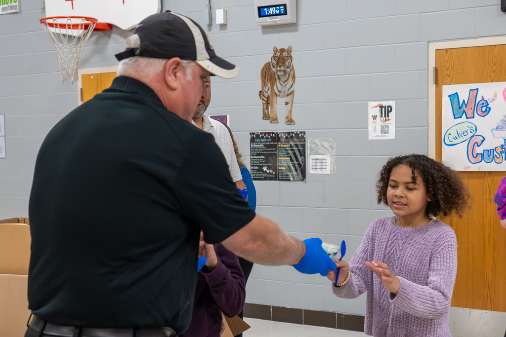 In celebration of April being the Month of the Military Child, Culver’s of St. Robert provided custard sundaes to students and staff at Waynesville Schools during the week of April 20-24, including at East Elementary on April 22, 2026.  A special thanks goes to Shaun Morris of Culver’s who donated approximately 7,000 custard sundaes, Ed Morse Ford for providing the vehicles for transporting the custard, Rick Harne for organizing the week, Paula Tackett for organizing the volunteers, Infuze Credit Union, USO, The Pulaski County Sewer District #1, and other volunteers who delivered and served the custard.  At East Elementary, Shaun Morris, owner of Culver’s in St. Robert, Stephanie Linville, FBC for Culver’s in the St. Louis area, and Michael Wieland, director of operations at Culver Franchising System, joined the volunteers to help hand out the custard. They are pictured next to a thank you sign created by East students.