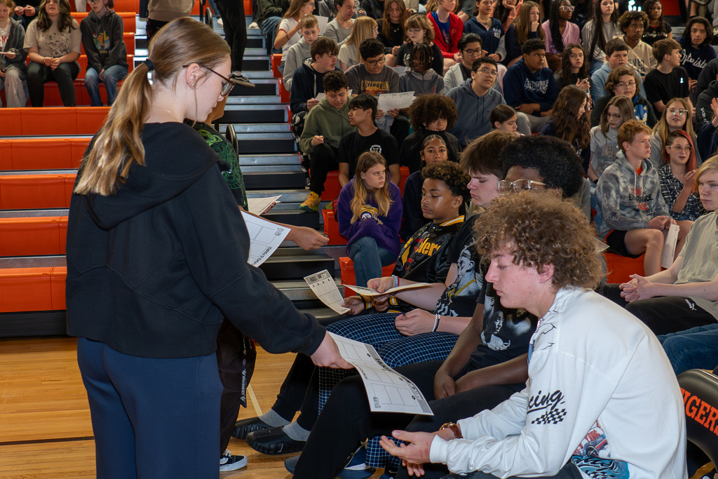 Student distribute handouts to go with Kym Laube 's speech