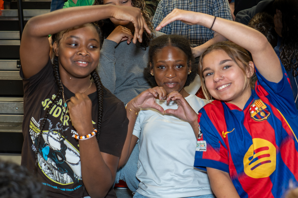 Three students making a heart
