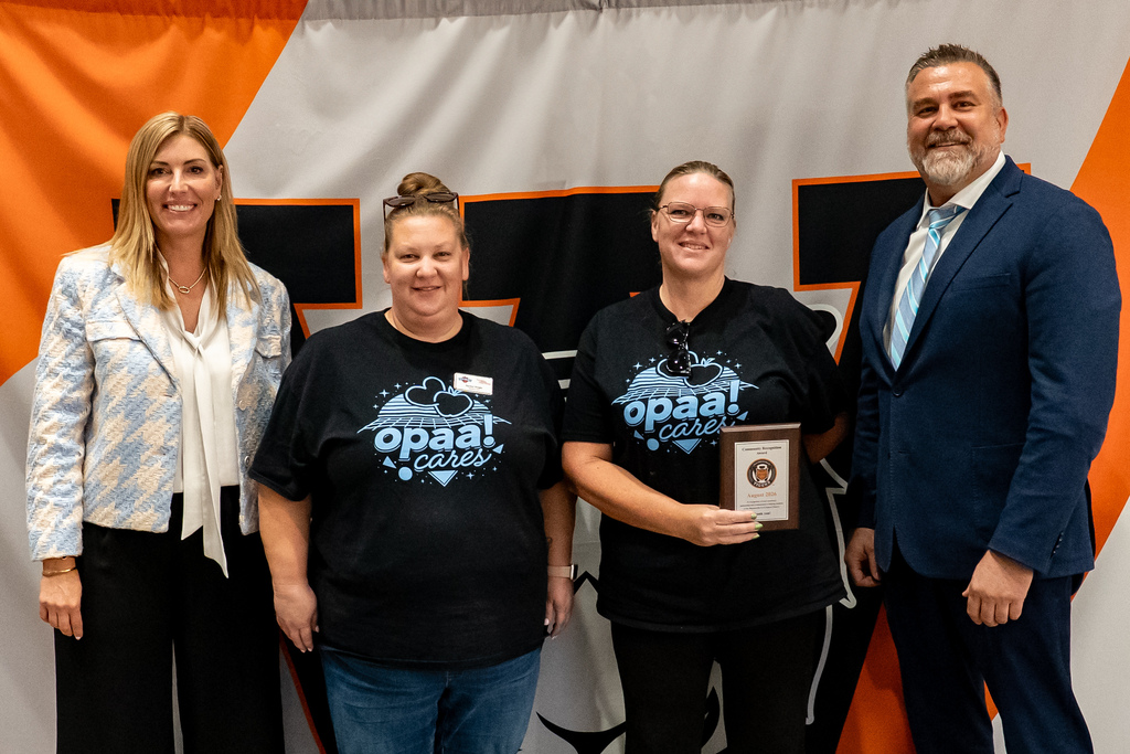 OPPA! being awarded community recognition plaque
