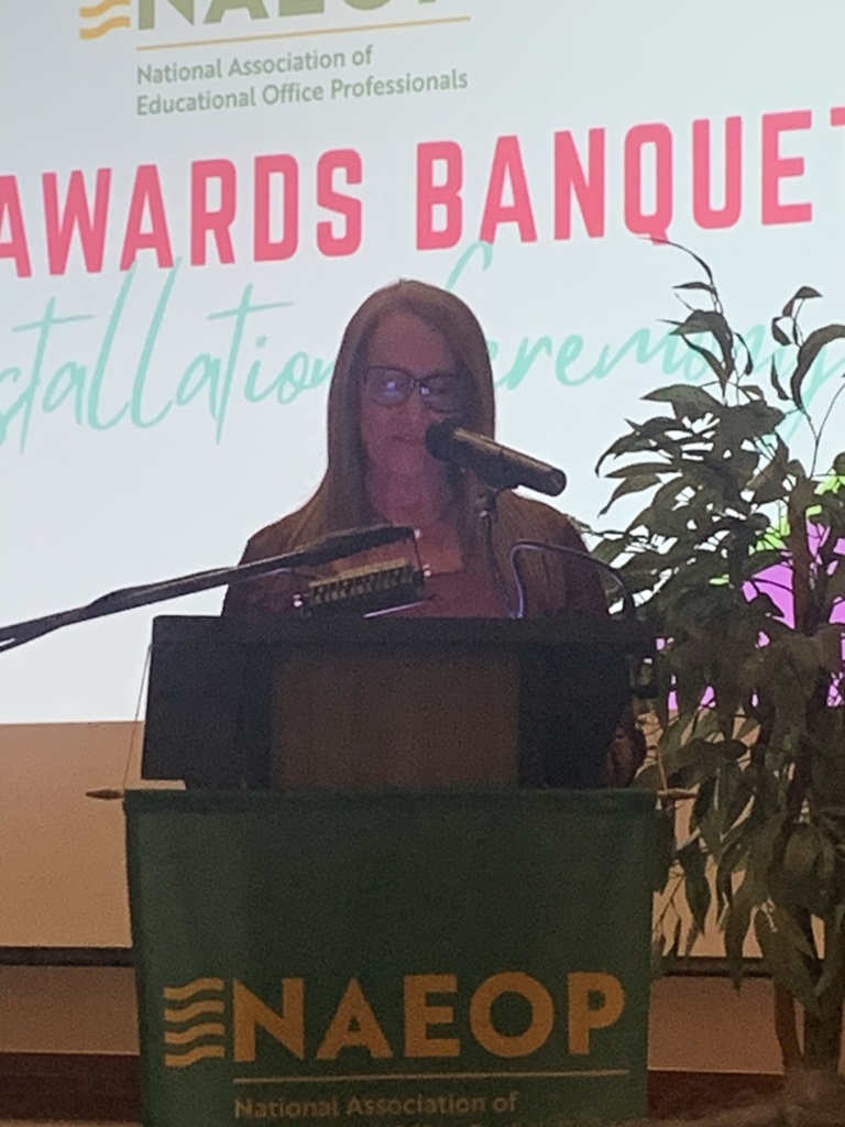 Marie Freeman giving speech at an awards banquet