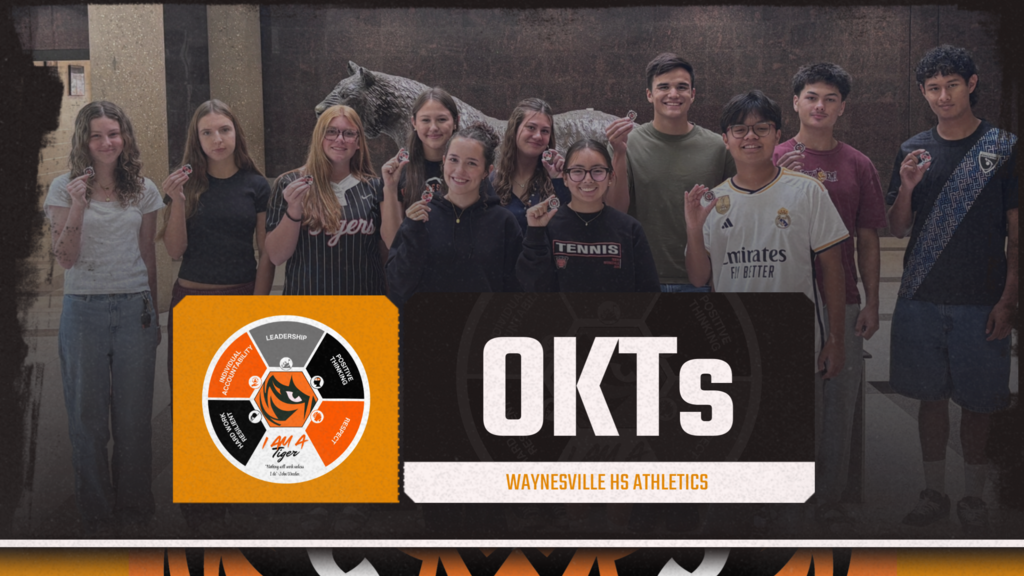 Picture of students holding a challenge coin. Image of the Portrait of a Tiger. OKTs is the title.