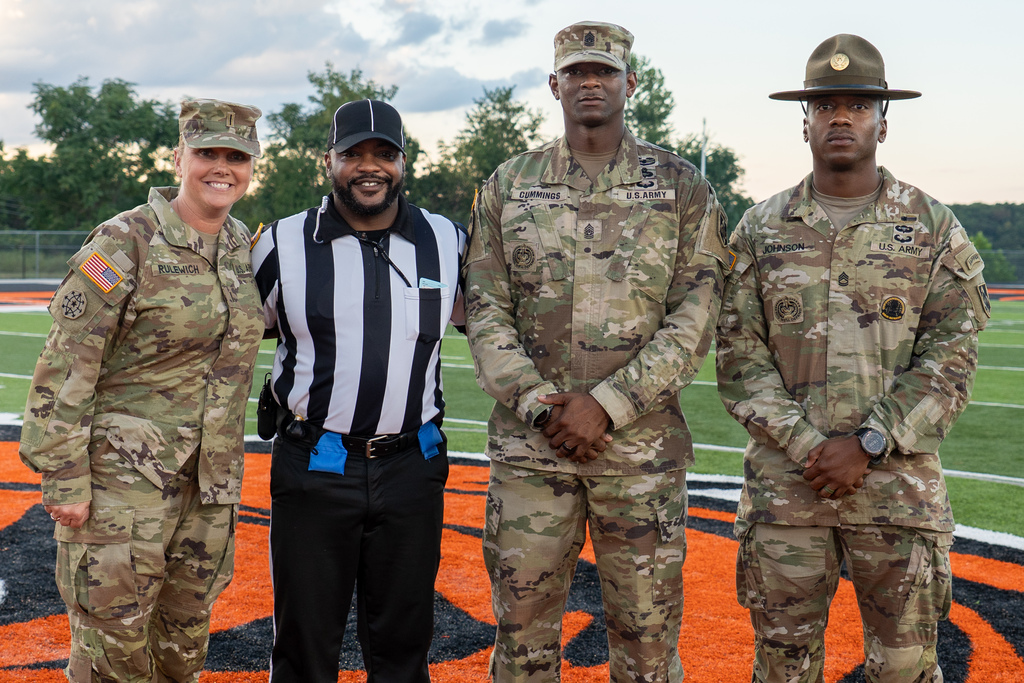 Fort Leonard Wood Soldiers with a referee on the field.