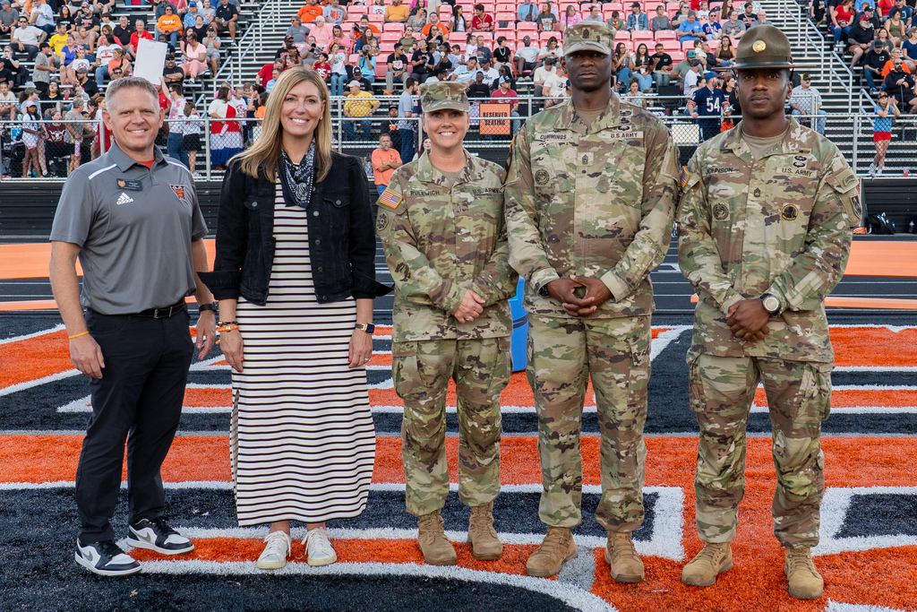 Participating in the ceremonial coin toss alongside the officials and team captains were Maneuver Support Center of Excellence and Fort Leonard Wood Command Sergeant Major Keyon Cummings and Command Chief Warrant Officer Angela Rulewich; Waynesville R-VI Superintendent Hilary Bales; and Waynesville High School Principal Brian Vernon.
