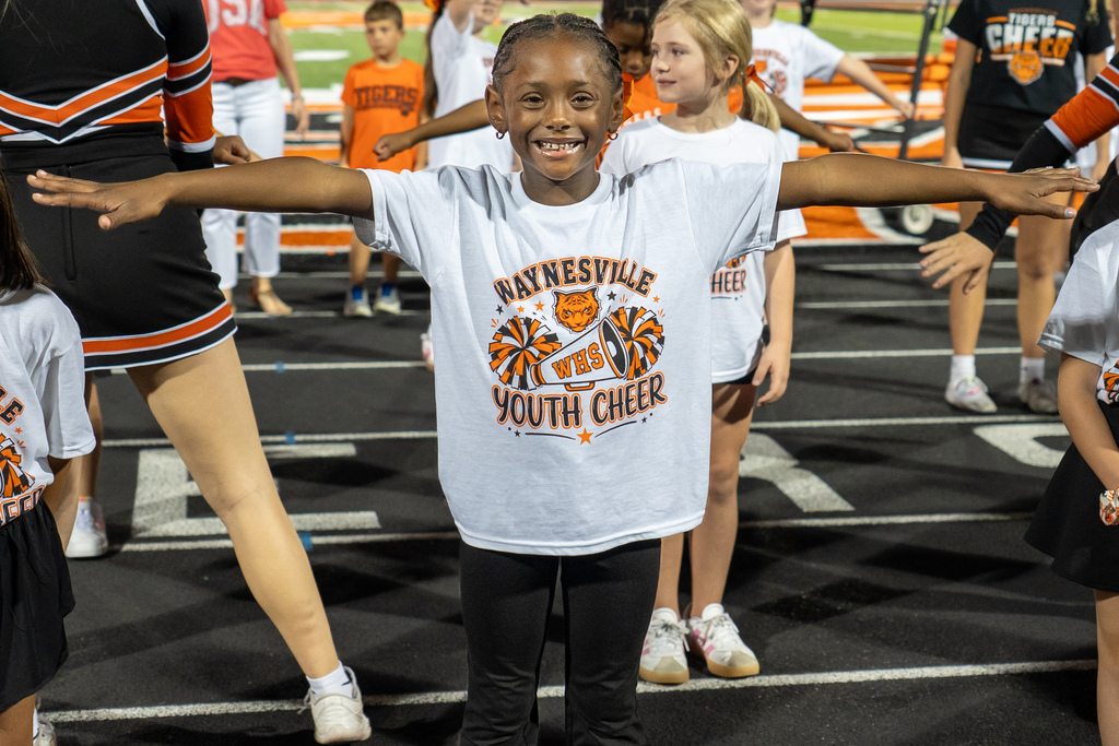 Future cheerleader with her arms outstretched