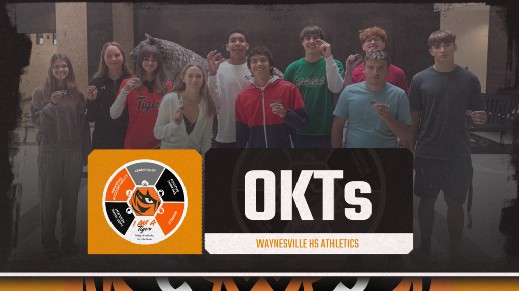Picture of a group of students holding a Portrait of a Tiger coin, OKTs as the title with the qualities of a tiger listed.