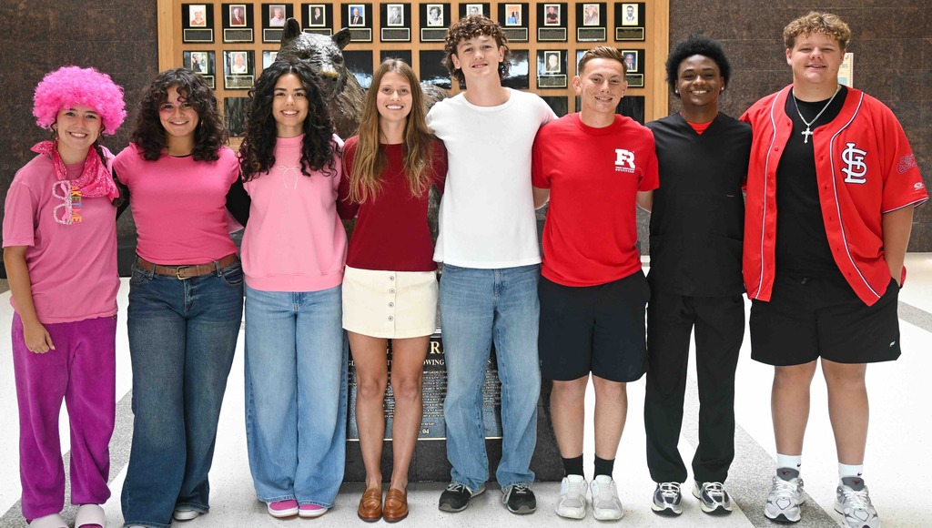 This photo shows 8 students posing for a photo for homecoming court