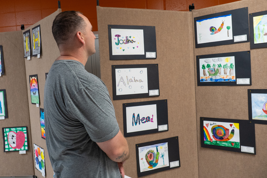 Man looking at artwork on display.