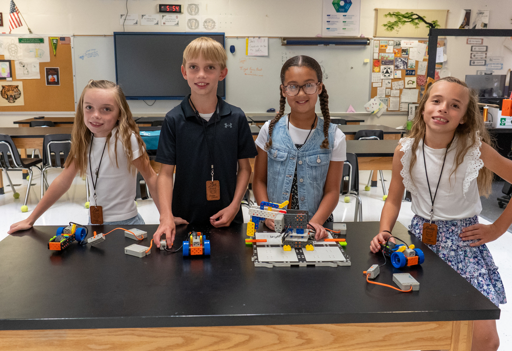 4 students with their robotics demonstration