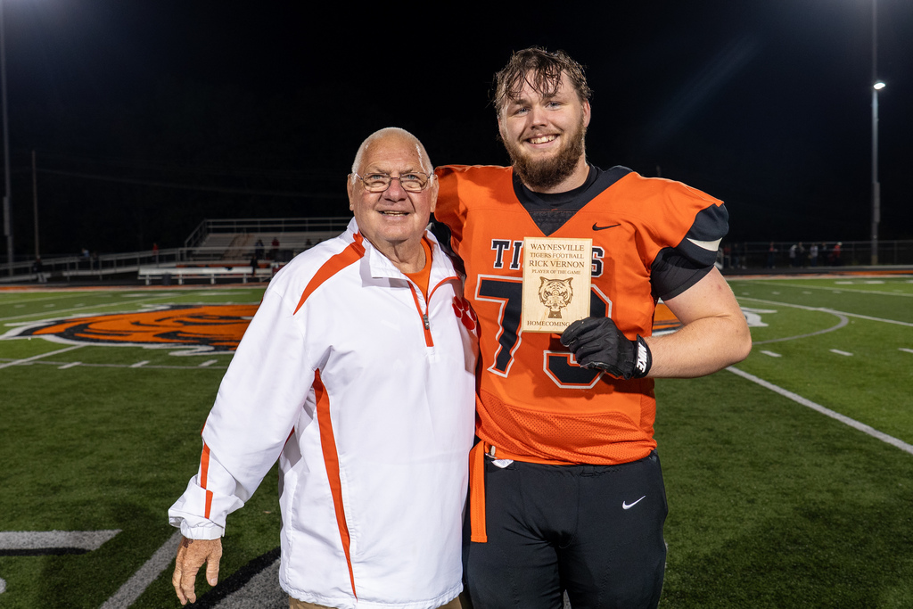 Football player receiving award during football game