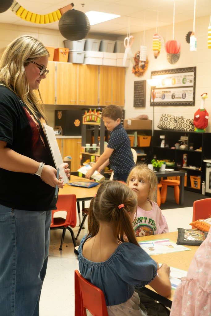 A female high school student watching over two little girls.