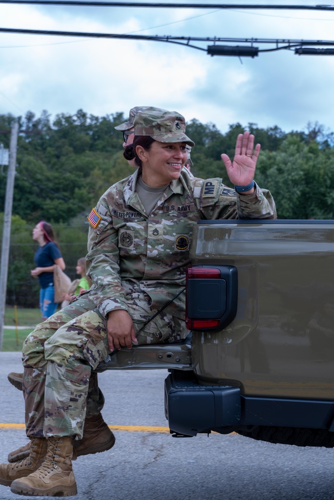 Female U.S Soldier in uniform smiling and waving  
