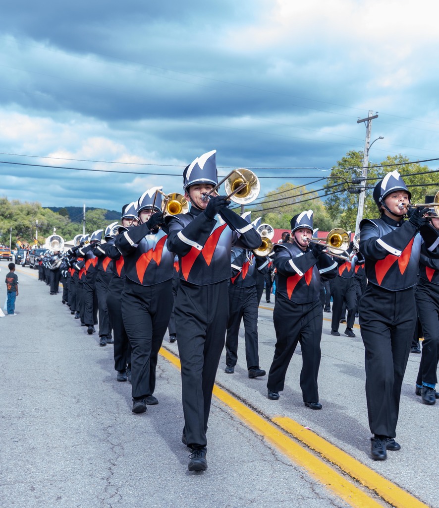Waynesville High School band dressed in uniform playing their instruments and march down route 66.