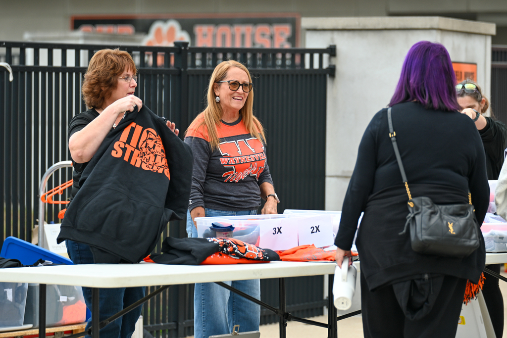 Two staff members selling Waynesville geer. 