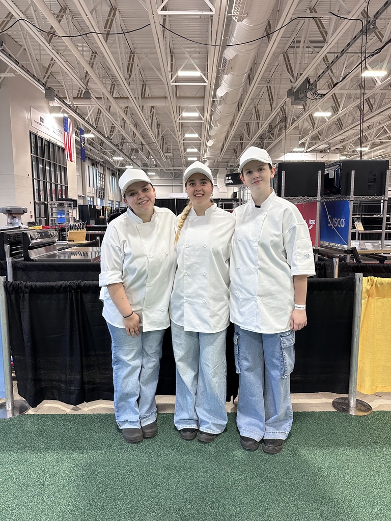 Three students in white uniforms.