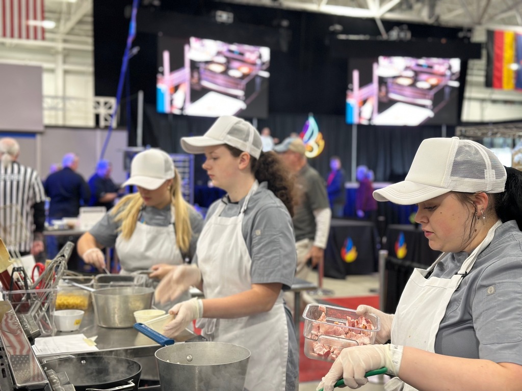 Molly McDermitt, Cycila Keeney and Samantha Etheridge cooking at the competition.