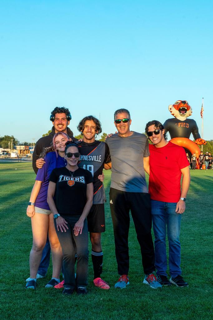 A male senior on the Waynesville soccer team being walked out on senior night by his family.