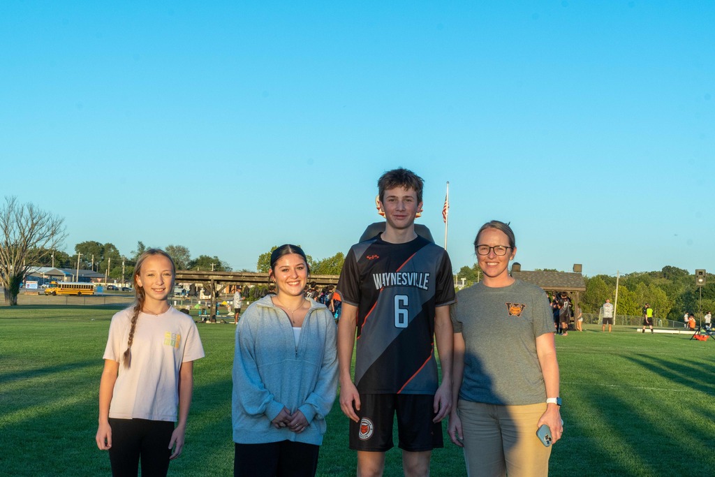 A male senior on the Waynesville soccer team being walked out on senior night by his family.