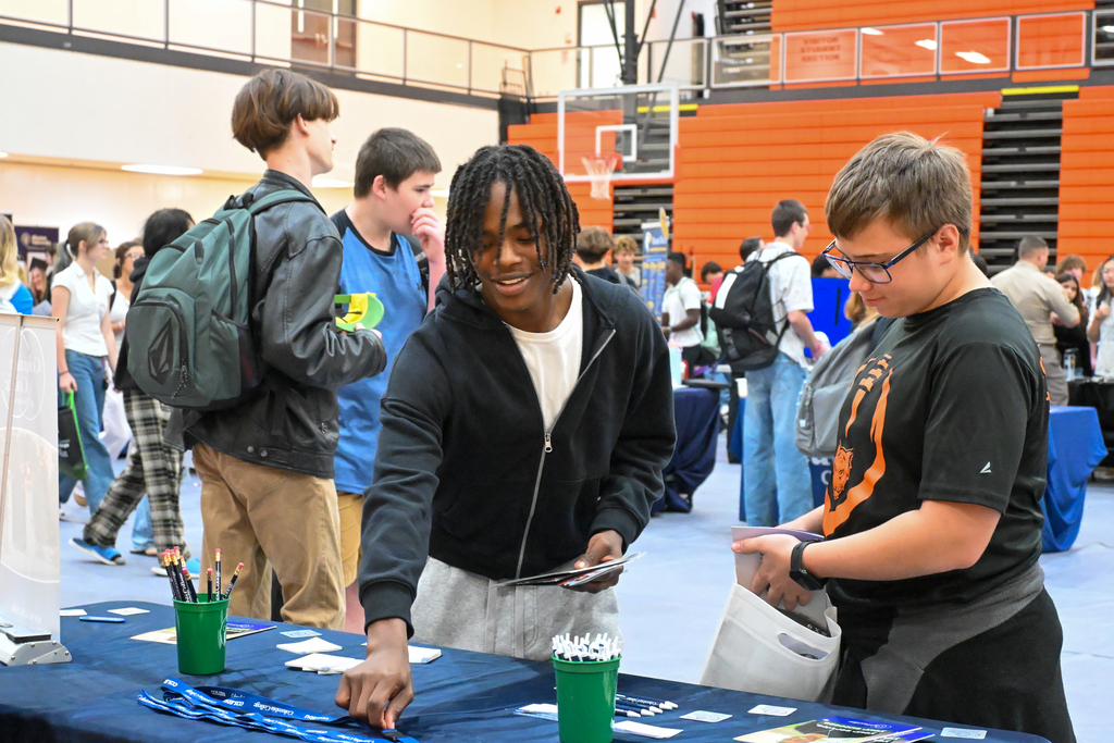 students picking up things that the college has brought for students
