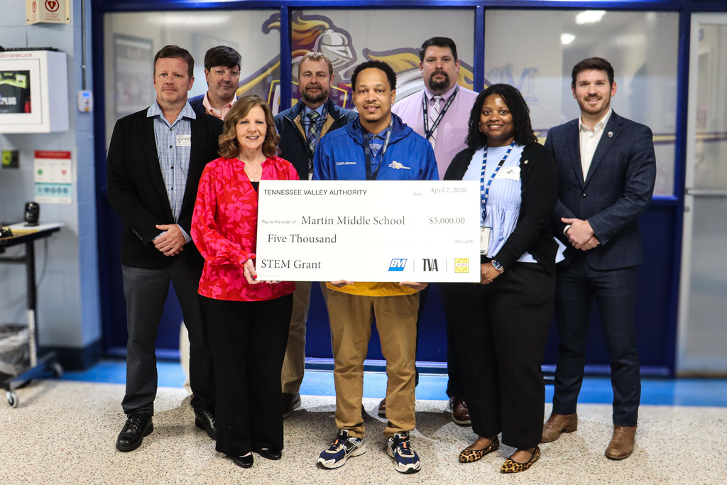 School leaders and partners pose with a large $5,000 Tennessee Valley Authority STEM grant check presented to Martin Middle School.