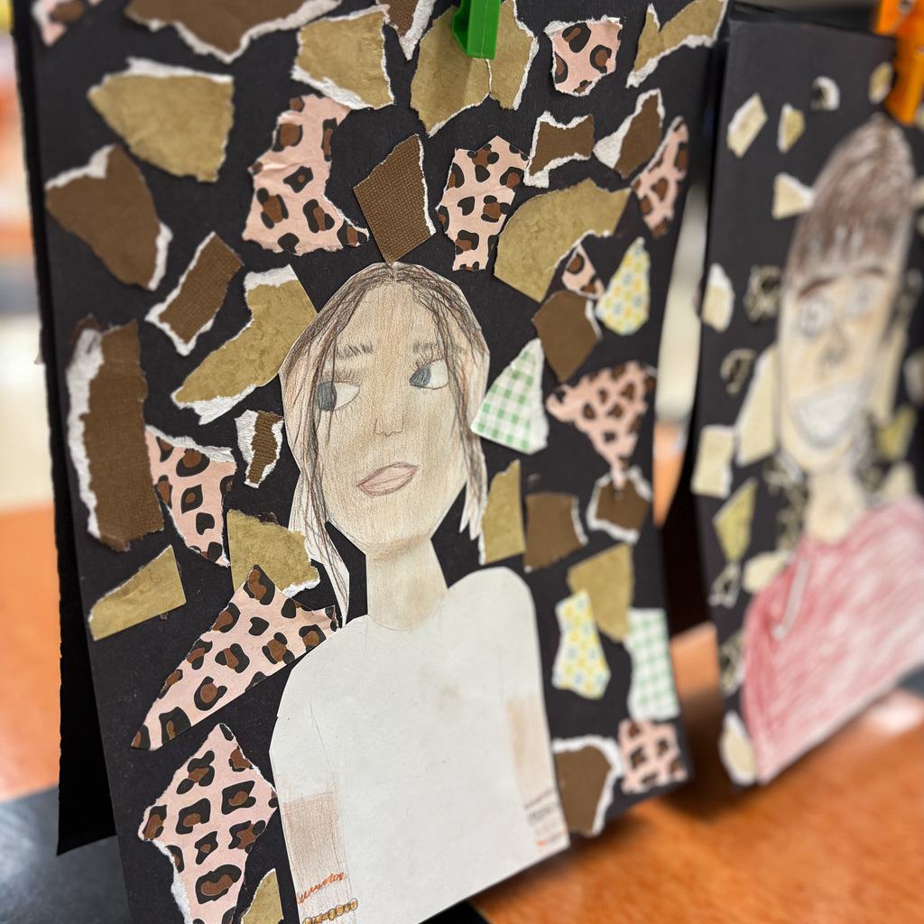 A portrait of a woman and another of a man hang on a wall. Both are made from torn and layered paper.