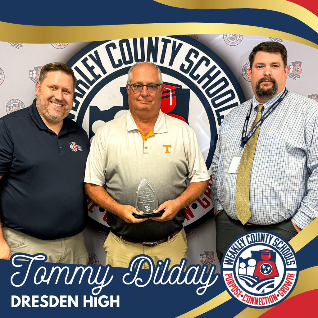 Three men stand before a school logo; the middle man holds an award. Names and a school name are visible.