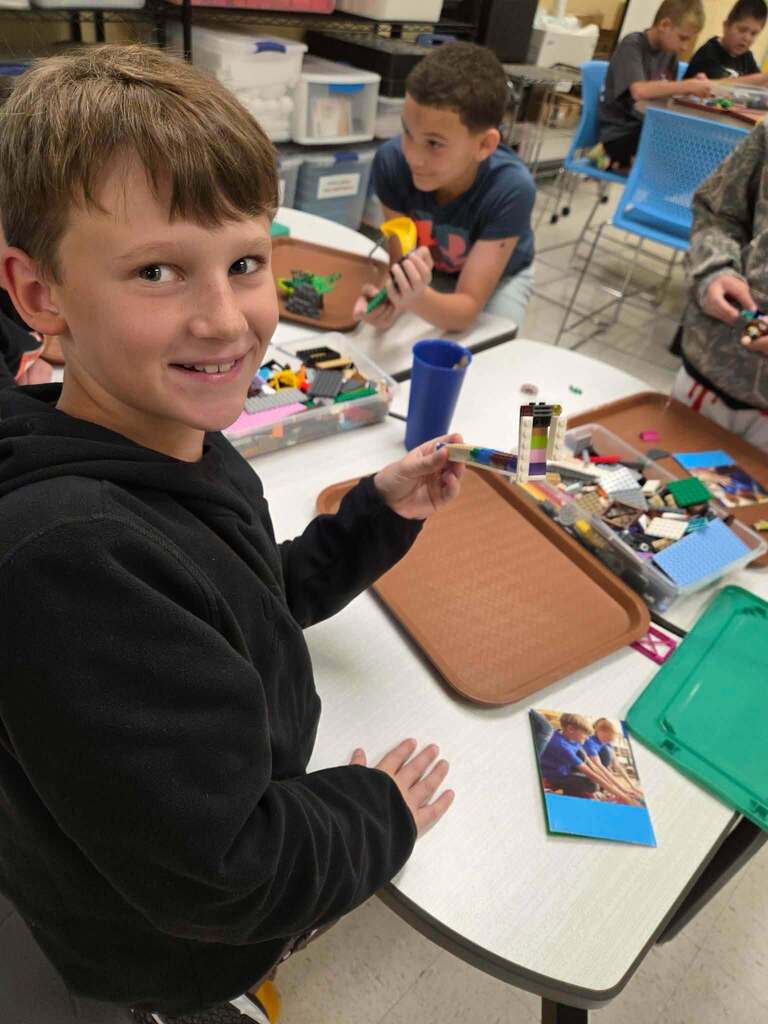 Student holding lego creation