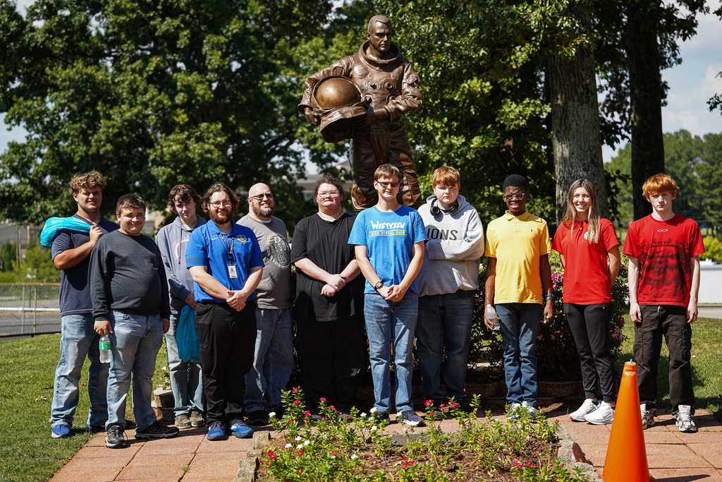 Dresden and Westview students and staff pose together outdoors in front of an astronaut statue at NASA’s Marshall Space Flight Center.