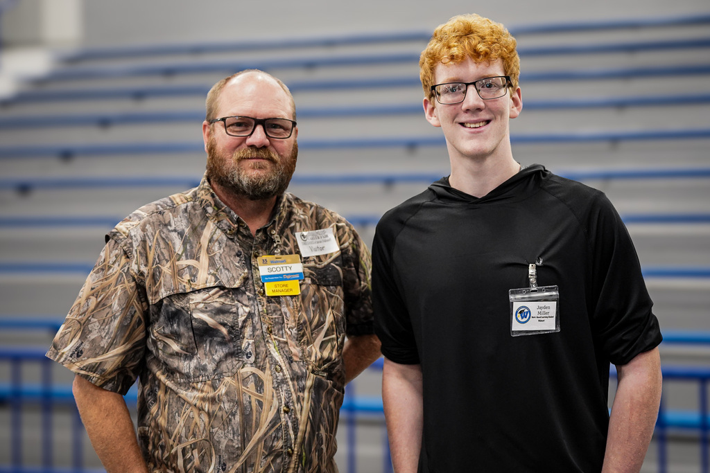 A work based learning student poses with his employer