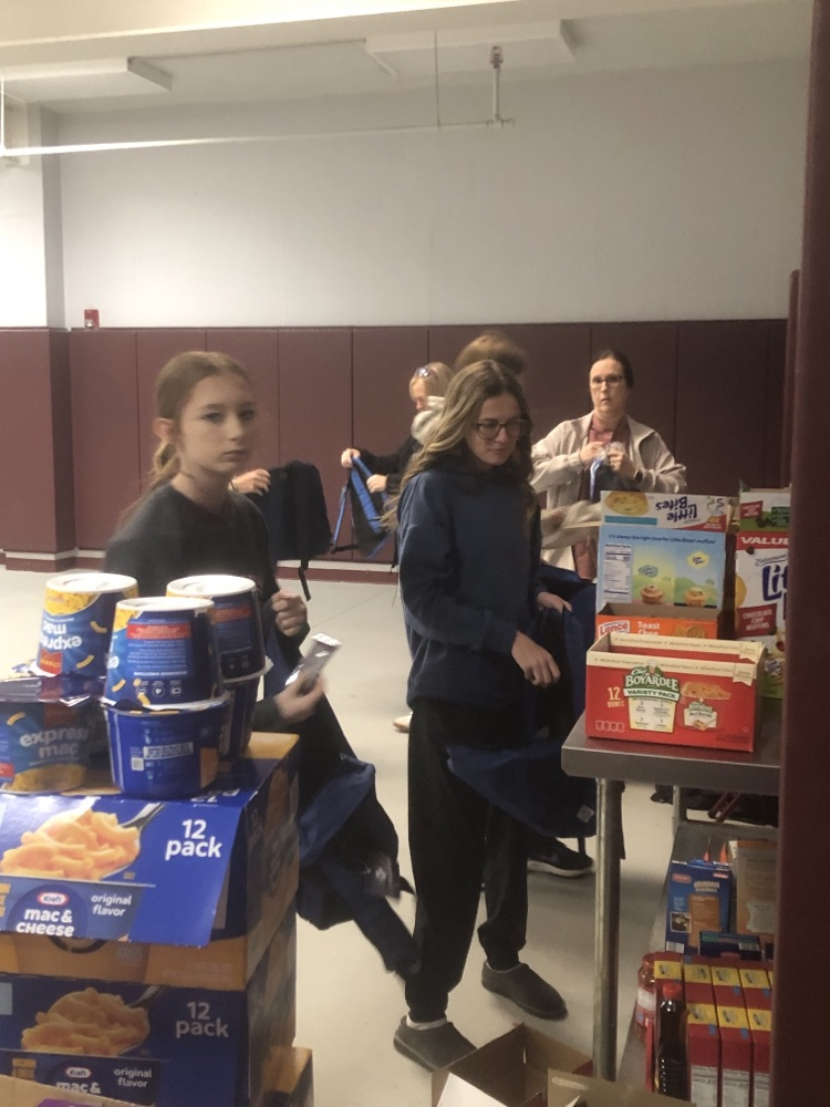 11/12 filling backpacks with food.