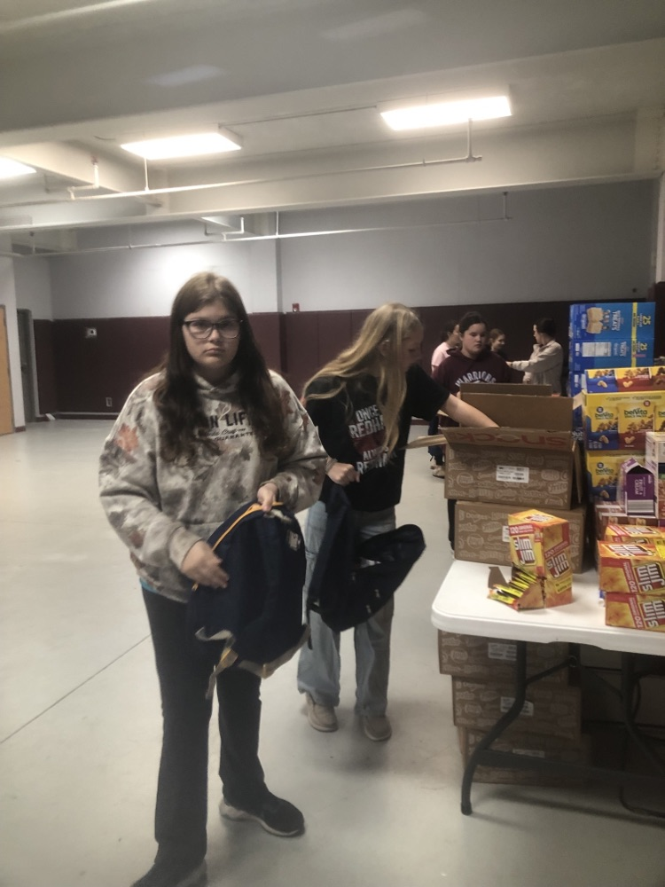 11/12 filling backpacks with food.