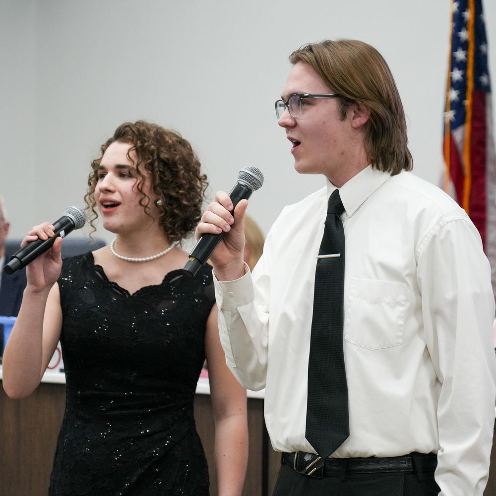 Students singing at board meeting