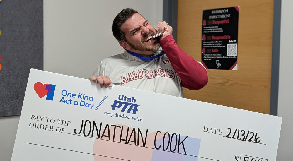 Photograph of Mr Cook receiving and award from PTSA and KIND teacher of the month for $500