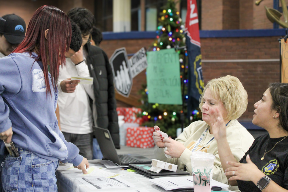 Carmen and Tiffany helping a student.
