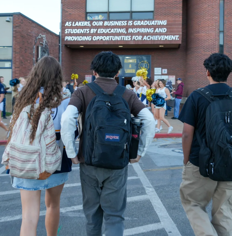 Kids walk into the high school for the first day of school. 