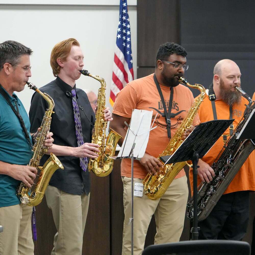 4 band teachers playing saxaphones