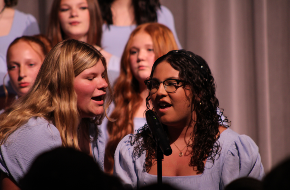 Two students singing at the Fall Choir Concert.